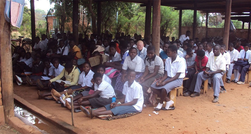 Students at Ngowe Community Day Secondary School learning in a carport Students at Ngowe Community Day Secondary School learning in a carport