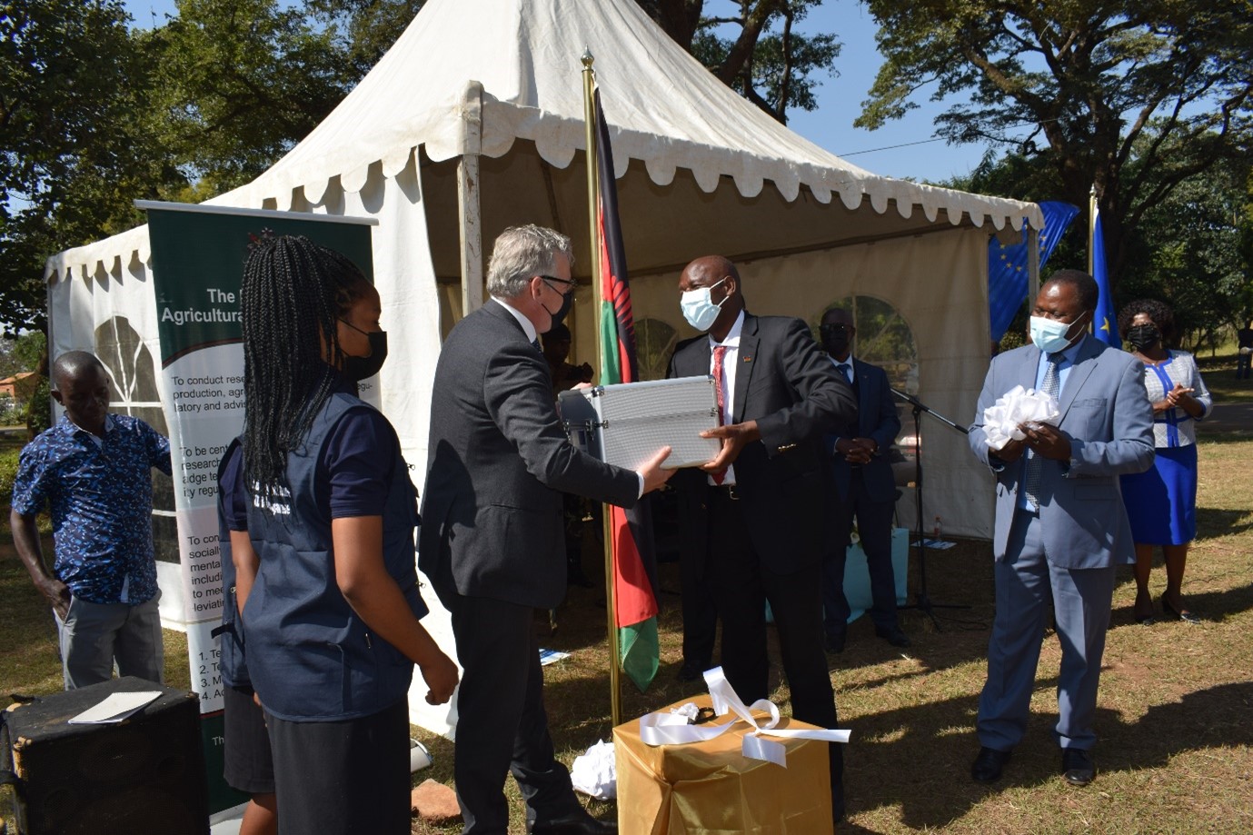 The Minister of Agriculture, Hon. Lobin Lowe, MP, officially receiving symbolic Research Equipment from the EU Ambassador to Malawi, HE. Rune Skinnebach,